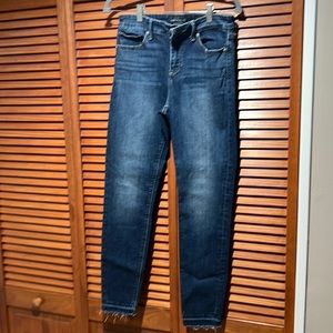 Lucky Brand denim jeans. Stone washed look with frayed hem.
